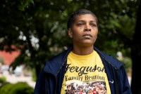 A portrait of a woman wearing a shirt that has a picture of her family at a reunion celebration.