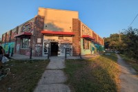 A photo of a store exterior with graffiti tags on the outside.