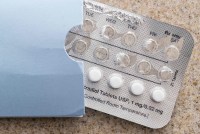 A partially used blister pack of pills is shown on a countertop