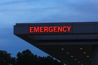 A red emergency sign on the side of a building