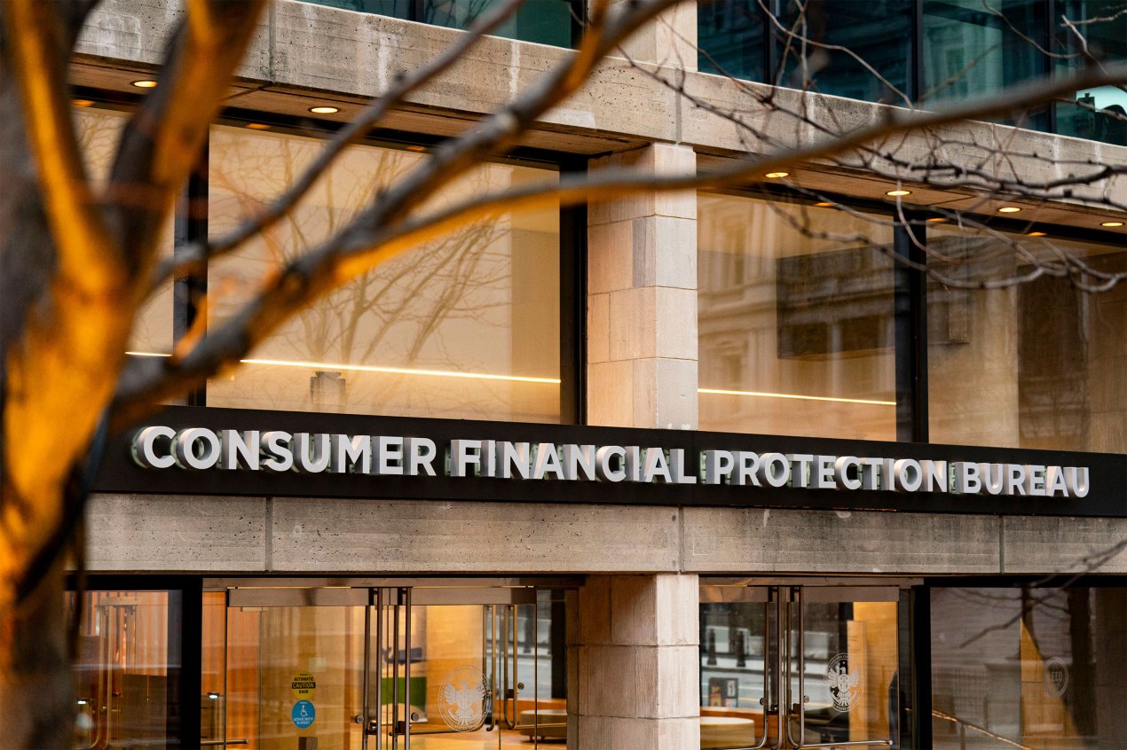 A photo of the CFPB headquarters. A tree is seen in the foreground.